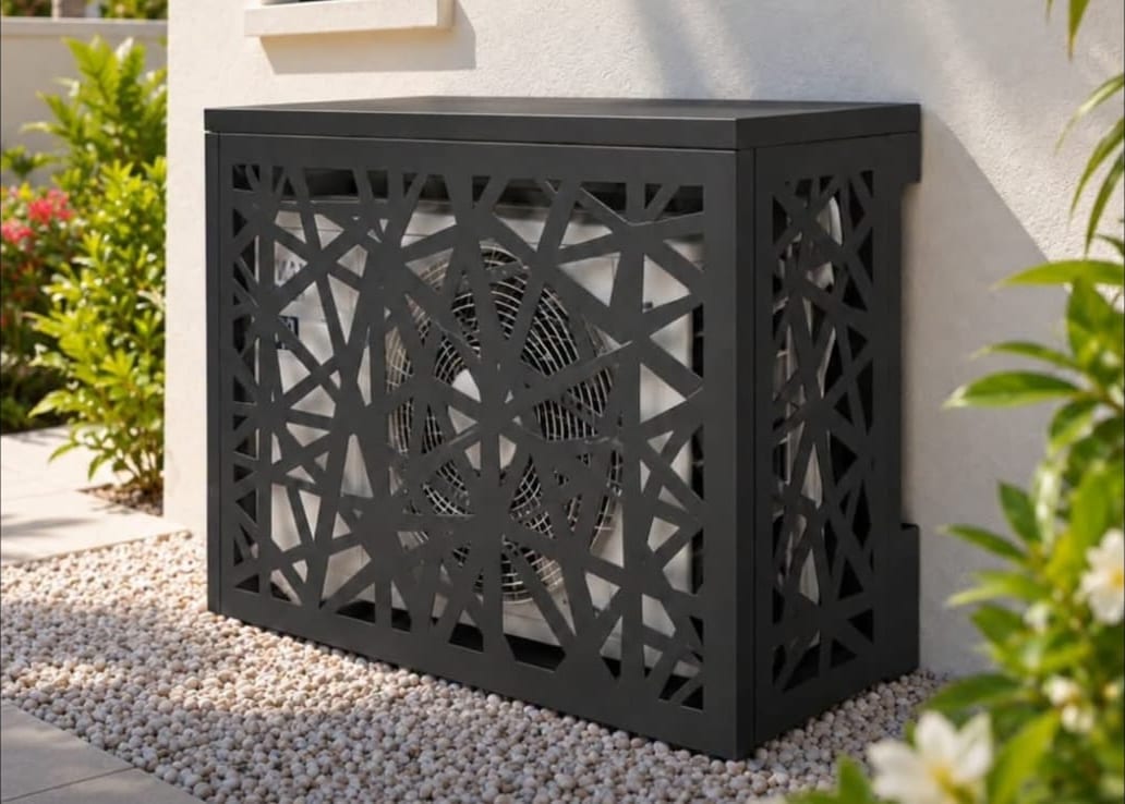 Black laser-cut aluminium cover screening an outdoor air conditioning condenser in Anguilla
