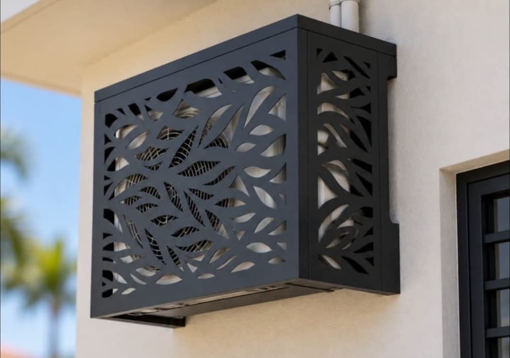 Charcoal laser-cut aluminium air conditioning unit cover with a leaf pattern in Anguilla