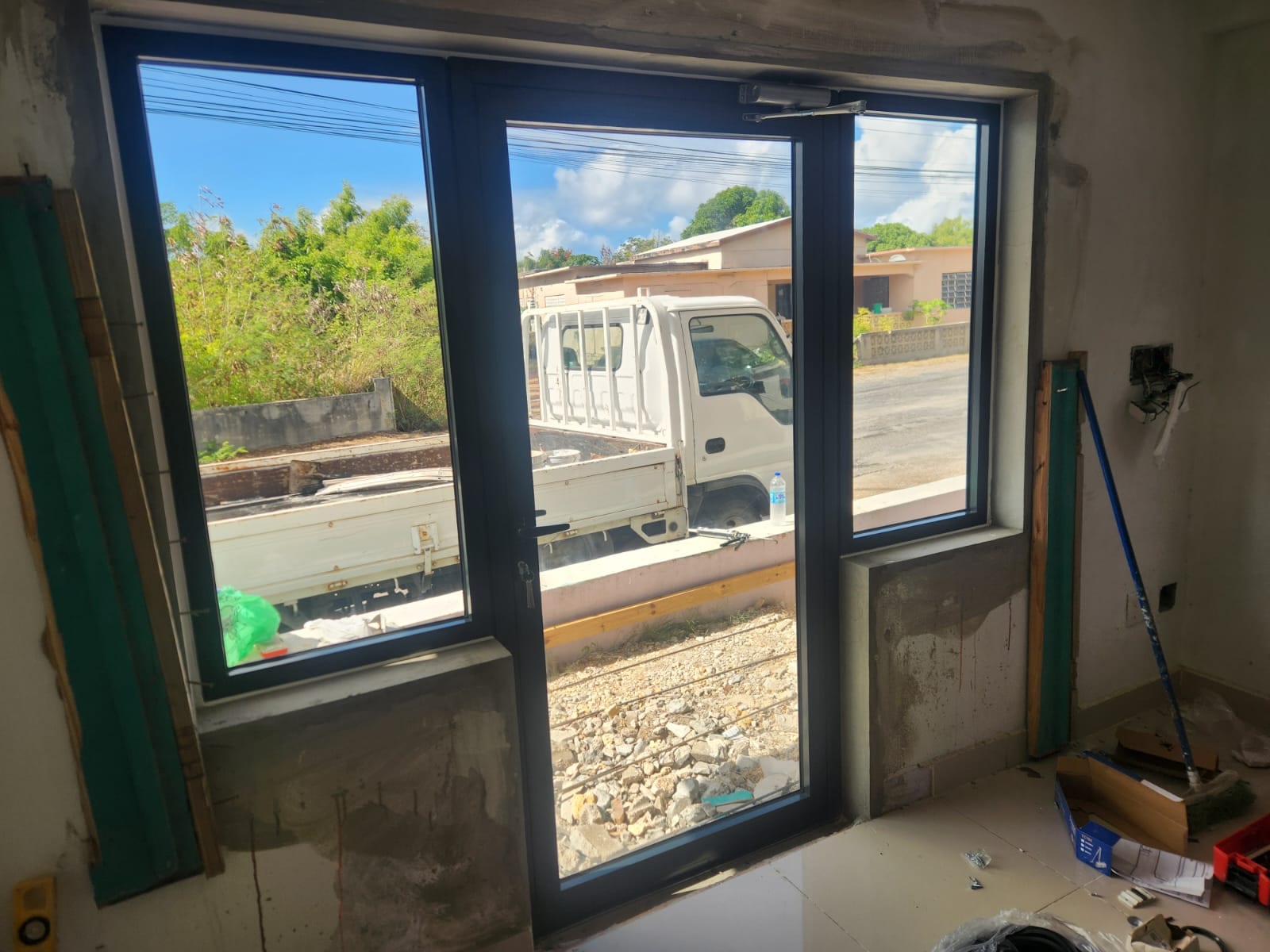 Wide interior view of a charcoal aluminium door and window wall fitted in a new build in Anguilla