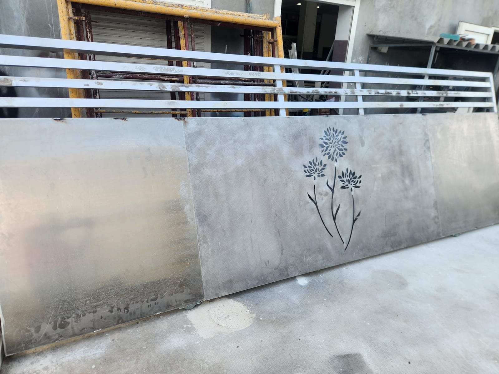 Laser-cut aluminium gate panel with a floral design being fabricated in the workshop in Anguilla
