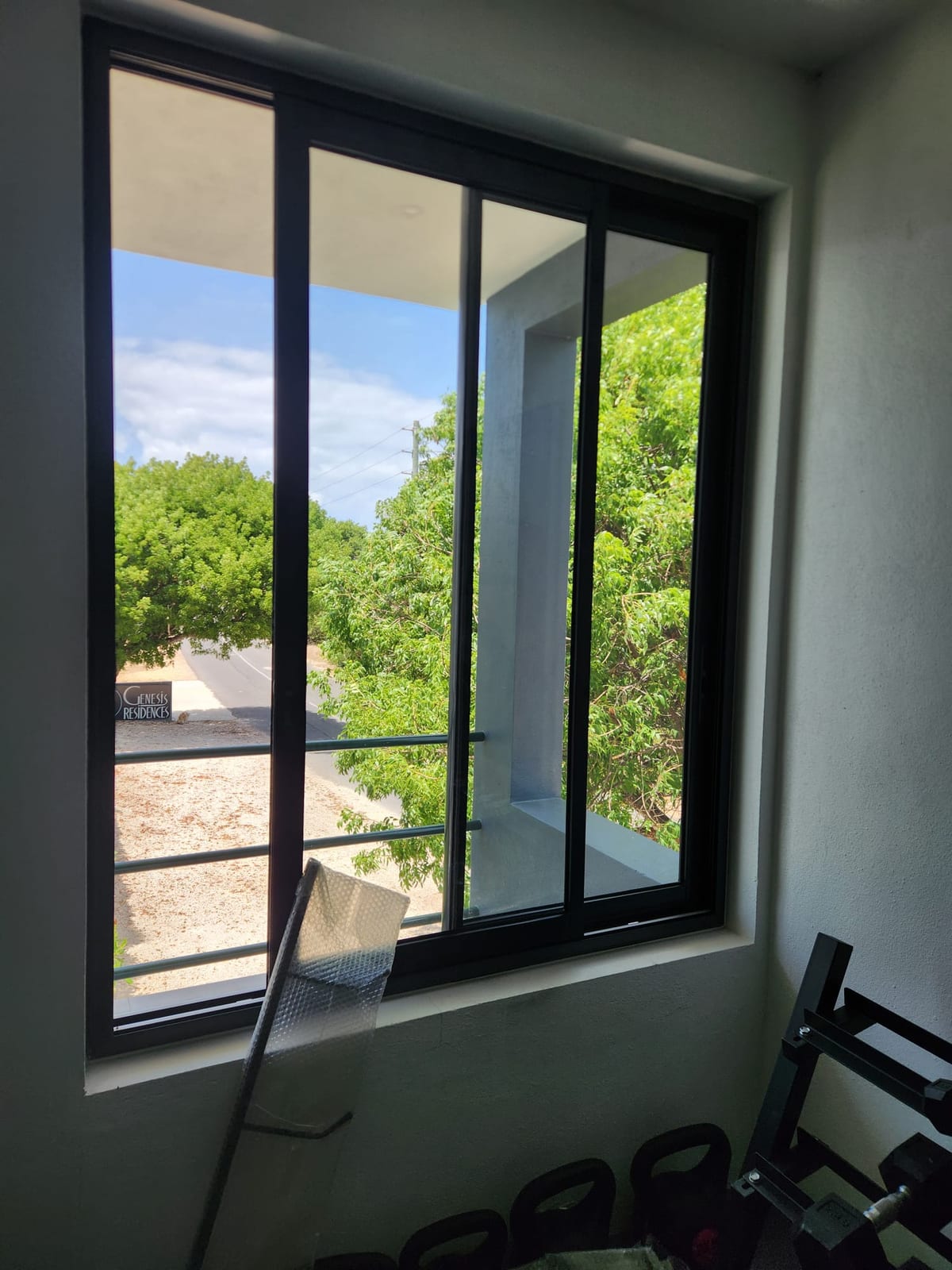 Black aluminium sliding window with a balcony rail at Genesis Residences in Anguilla